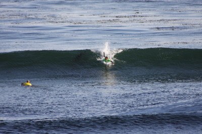 The surfer is being sucked back into the curl of the wave note the position as he is about halfway into the height of the wave.