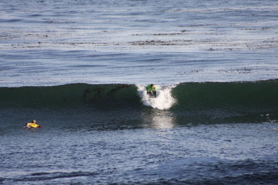The surfer has brought his knees up toward his chest and is preparing to stand. There is a stabilization period; about a second to gain your balance.