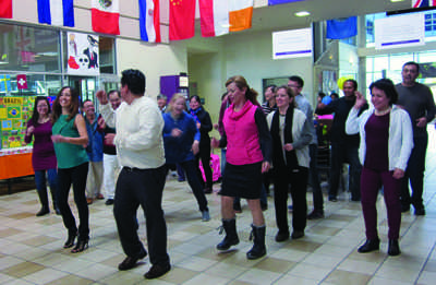 SJCC student Fernando Cortes (wearing black and white in the front) teaches students how to dance the Merengue on Nov. 16 at the Student Center. Cortes, 36, is a dental assisting major.