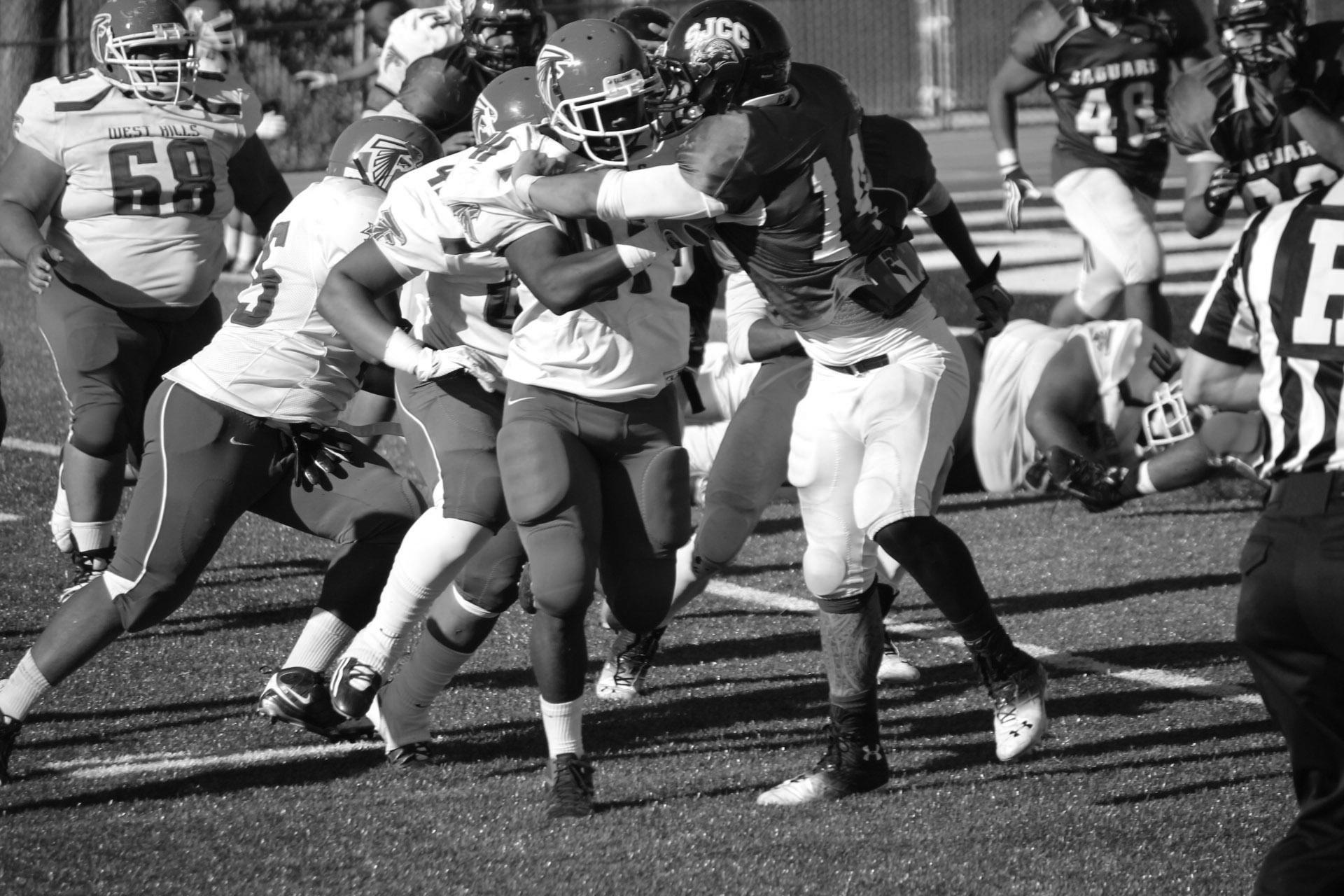 Jags linebacker Cy Pana, No. 14, pushes through the offensive line during the home game against West Hills on Sept. 28.