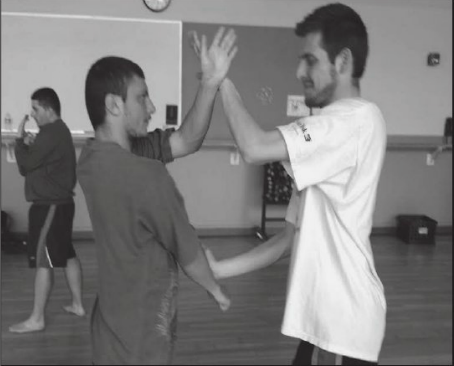 From Left, Carlos Sanchez, Robert Long shore and Robert Howery of MMA Club practice in the SJCC gym during spring semester.