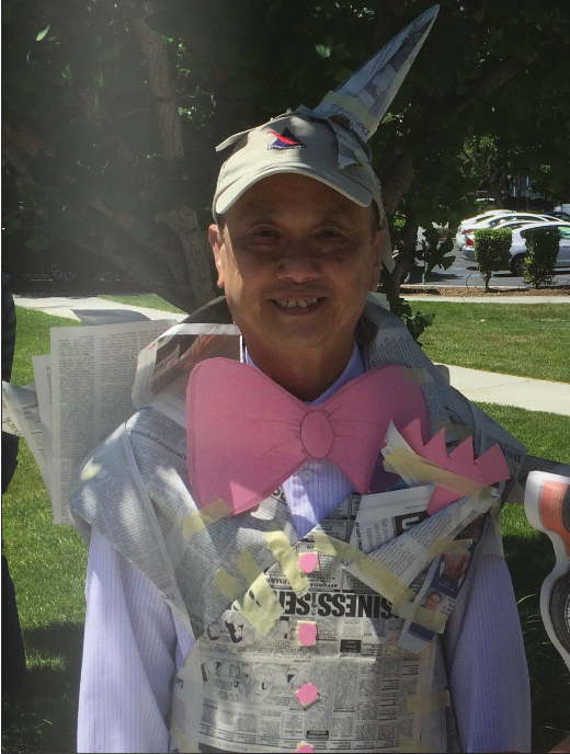Tony Nguyen, 63, displays his dinosaur-like costume entirely madeof newspaper.