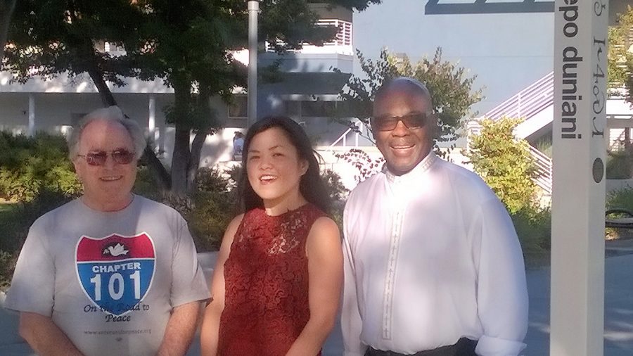 Philip Pflager, Cam Vu, Rev. Jethroe Moore II pose by peace pole
