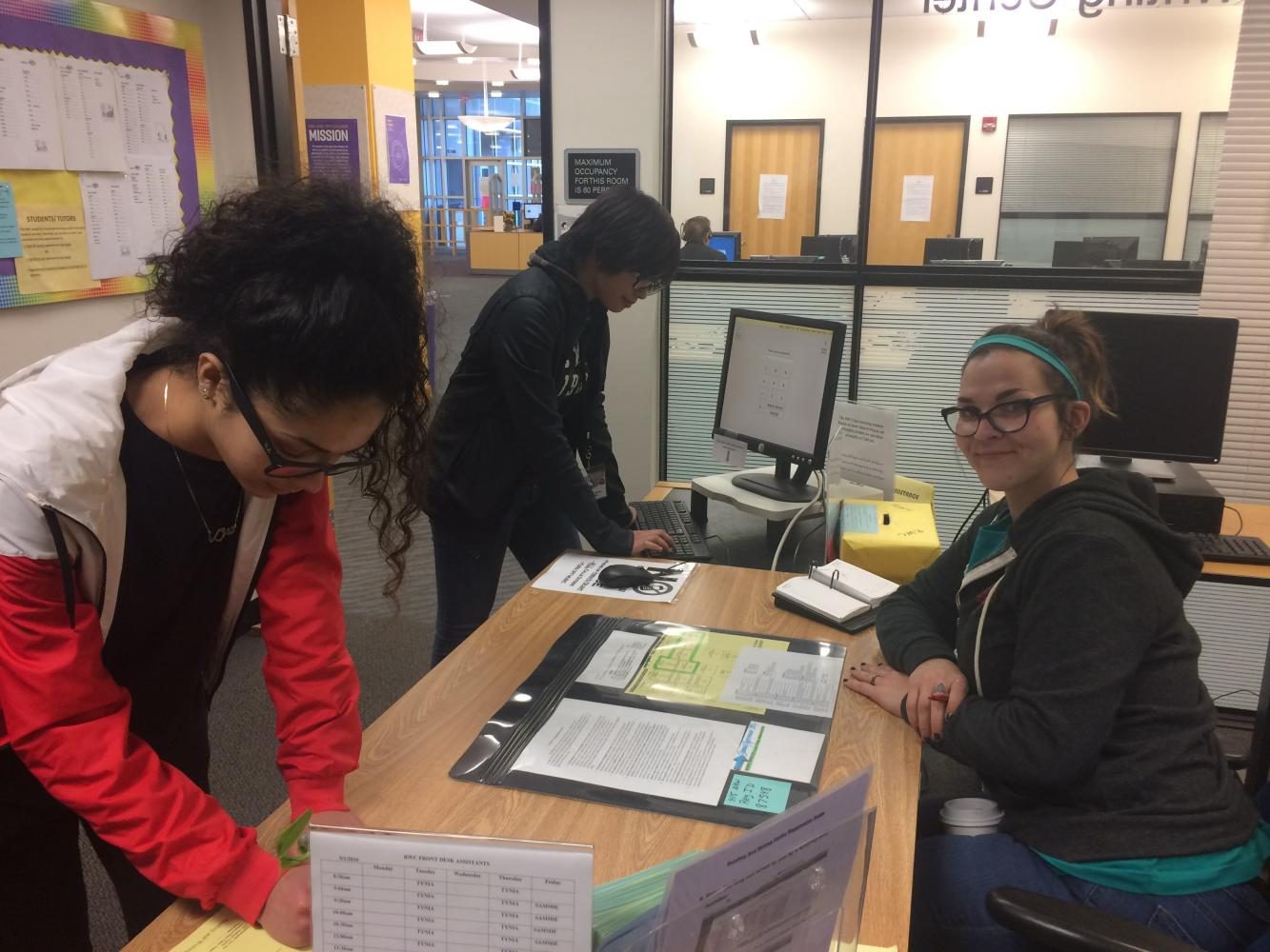 (Left) Peer tutors at the RWC Noor Basma, Lauren Apostle and Sammie Gilmore demonstrate how to sign in for a tutoring session.