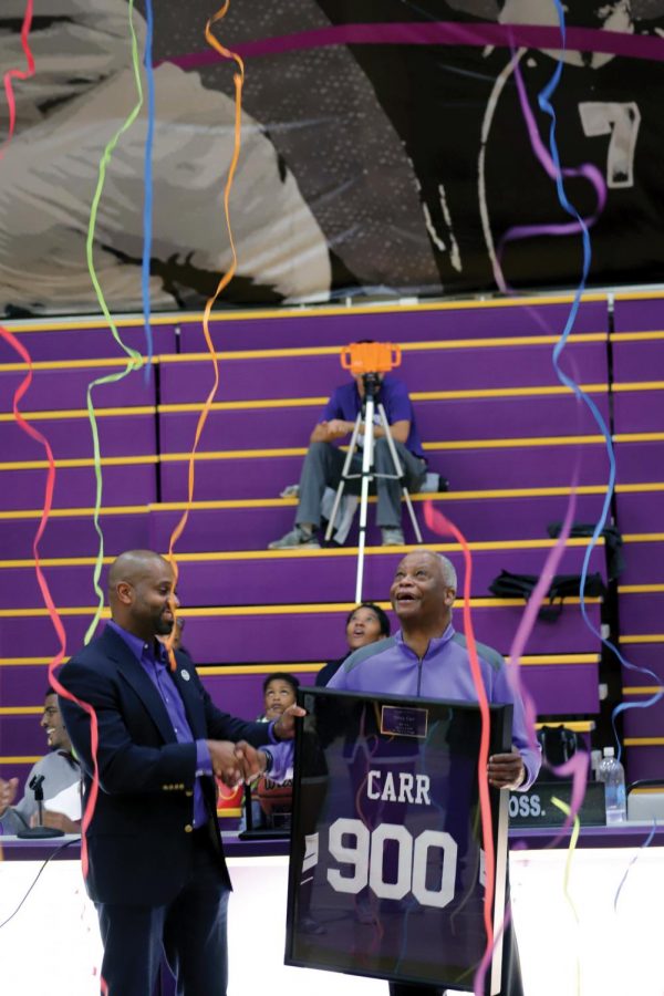 Streamers fall from the rafters as San Jose City College’s President Breland presents coach Percy Carr with a commemorative 900 win jersey before the start of the Jaguars home game against West Valley. Friday, Feb. 9. This is Coach Carr’s 44th season as head basketball coach for the Jaguars and he is the winningest African-American basketball coach in U.S. collegiate athletics.