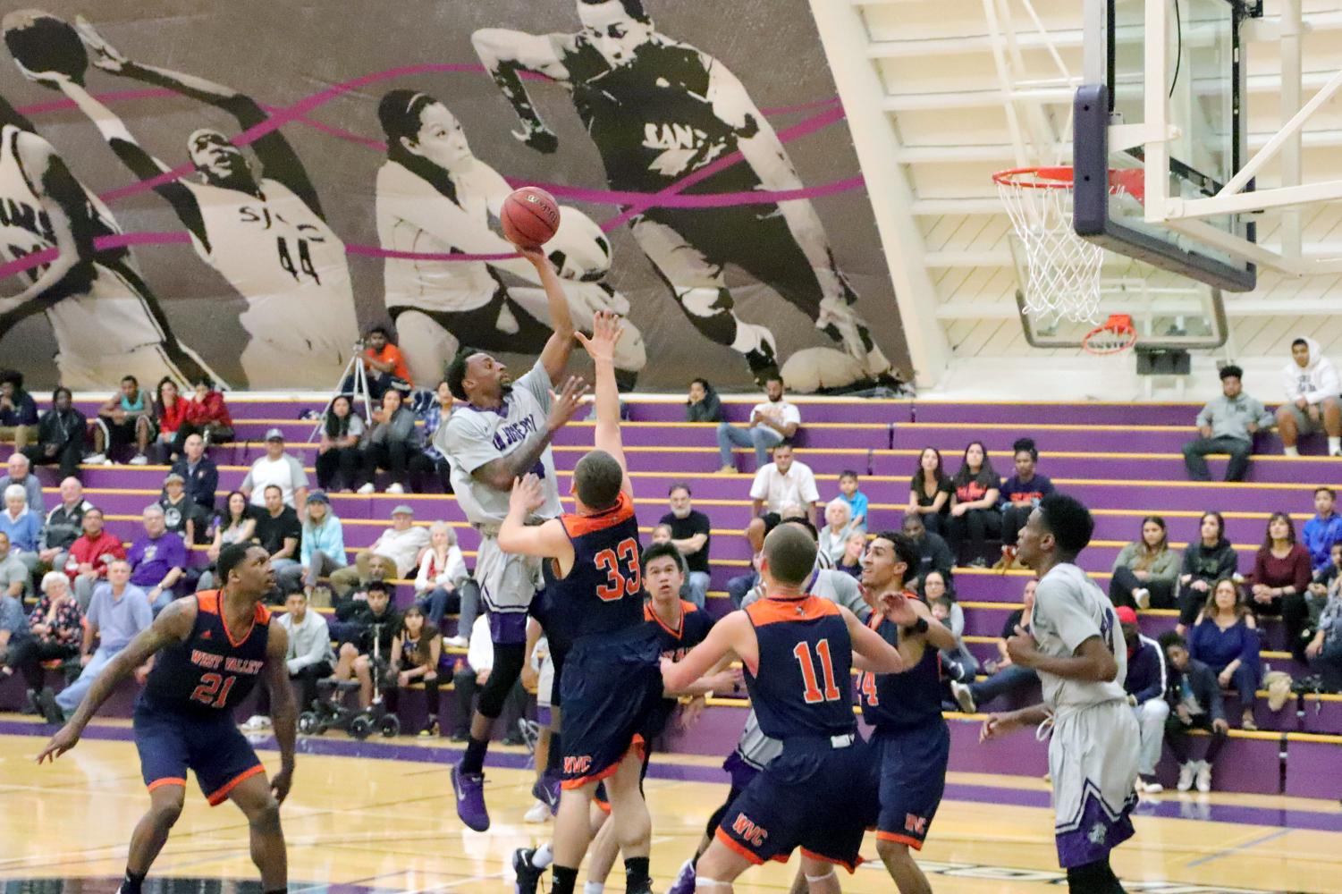 Jaguars Guard Donald Weathersby (34) pulls up in traffic for a mid-range jumper during the first half of the Jaguars game against West Valley on Friday, Feb. 9.