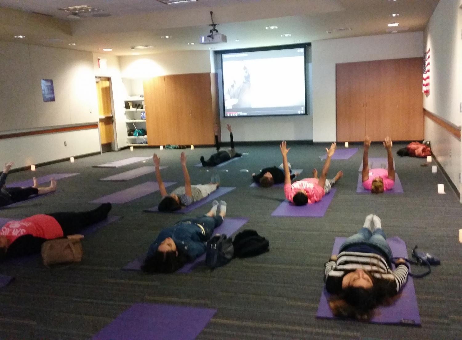 Students practice relaxing with yoga at Early Childhood Education's Go Go Stress event on Dec. 16, 2017.