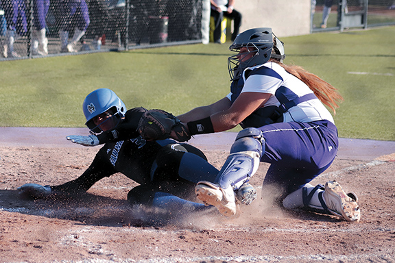 Jaguars Catcher Natasha Sachdeva (3) tags out Bulldogs Short Stop Leaness Donn (3) before she can score during the top of the fifth inning. The Bulldogs would finish the inning with the lead scoring the first two runs of the game.