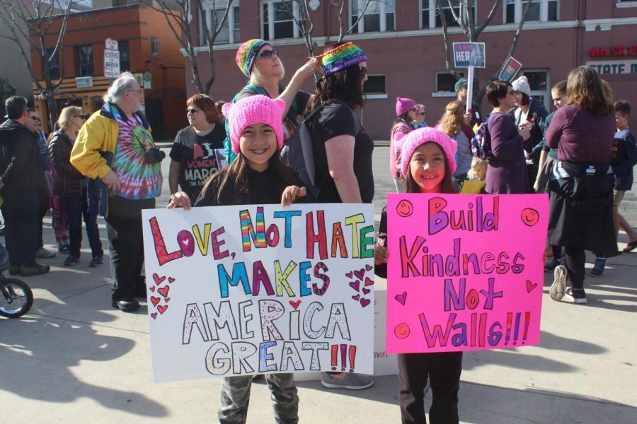 By Zoe Goddard, Girls proudly show off their homemade signs