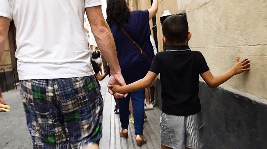 One of the team members holds hands with one of the refugee's children in Cadiz, Andalucia, Spain.