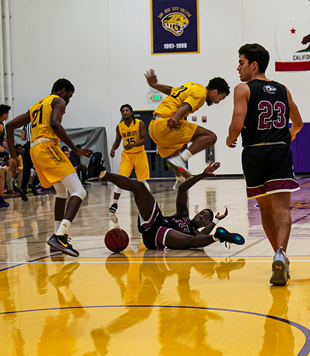 SJCC mens basketball player E. K. Okechukwu, No. 21, knocks down a Hartnell player at the Jaguar Sports Center on Feb. 8.