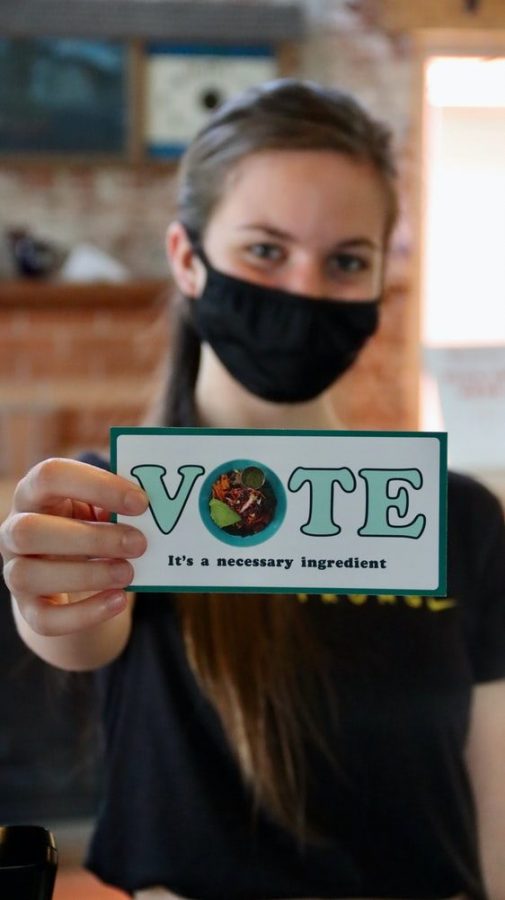 This photo from Unsplash images shows a woman promoting the idea to go out and vote. 