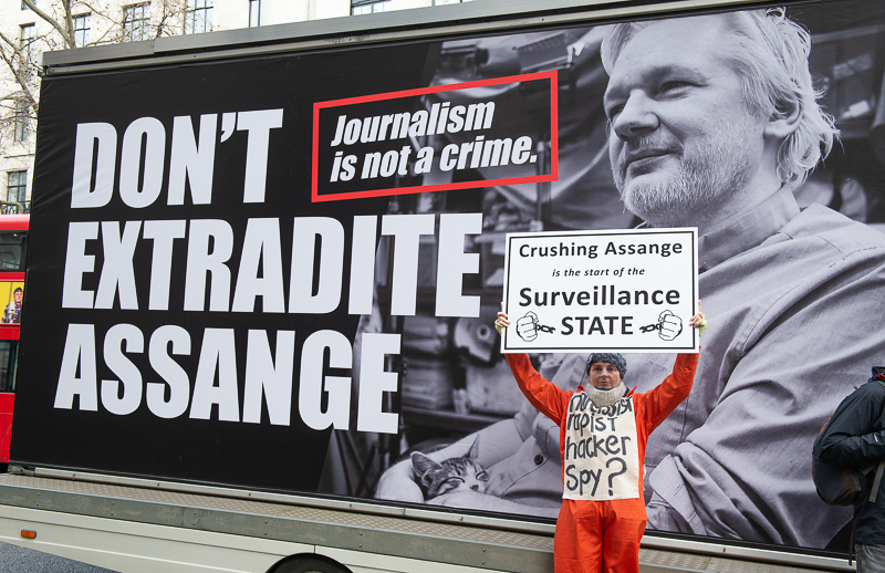 A supporter holds a sign at the “Don`t Extradite Assange” rally in London in protest of Wikileaks founder Julian Assange`s court hearing and possible extradition to the U.S. on Feb. 22, 2020.