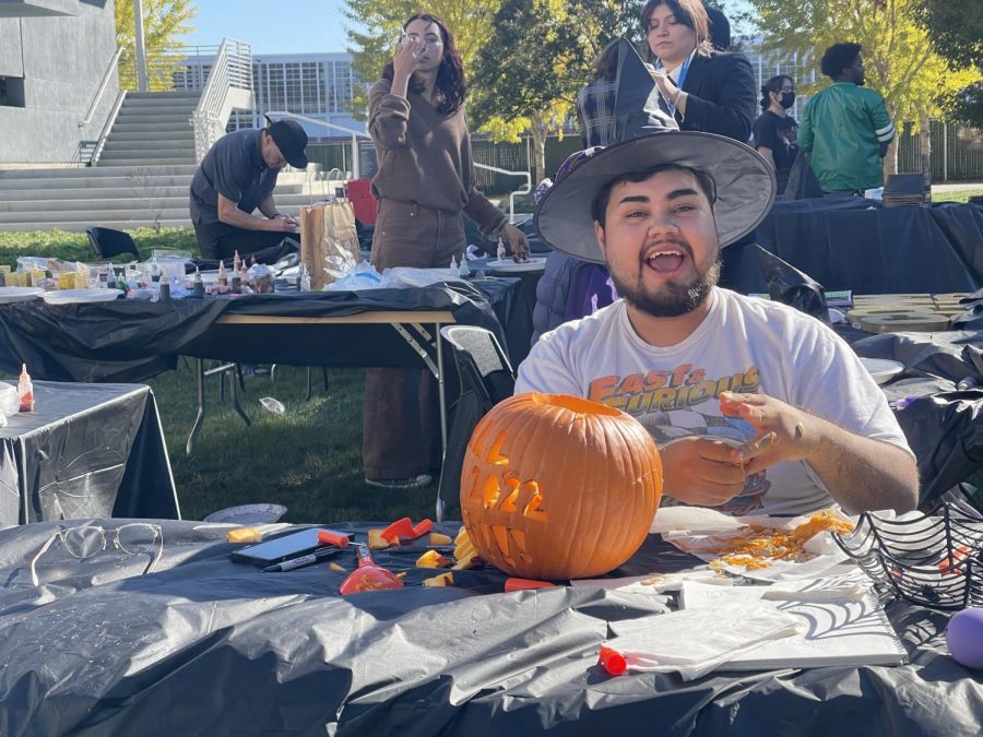 Carlos Castañed, psychology major, is competing in the pumping carving contest during the festivities, on Oct 27.
