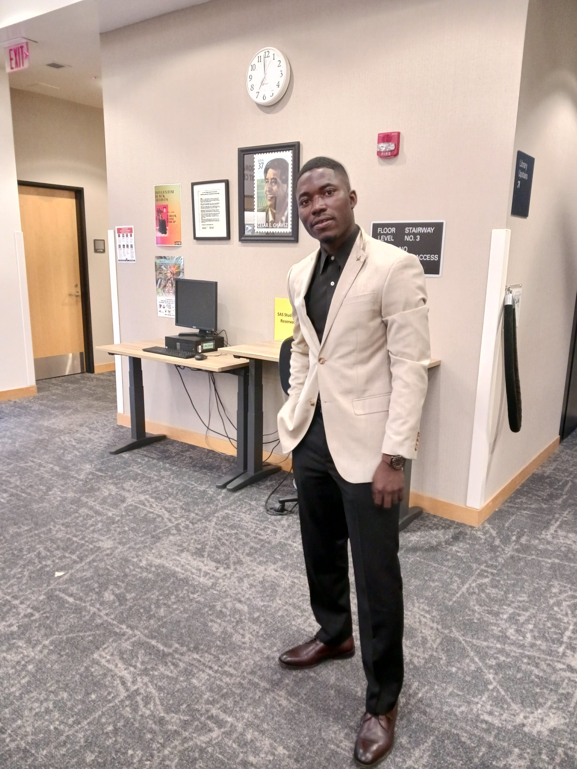 Student Koffi Amouzou in the Cesar E. Chavez Library near the Student Center at SJCC.