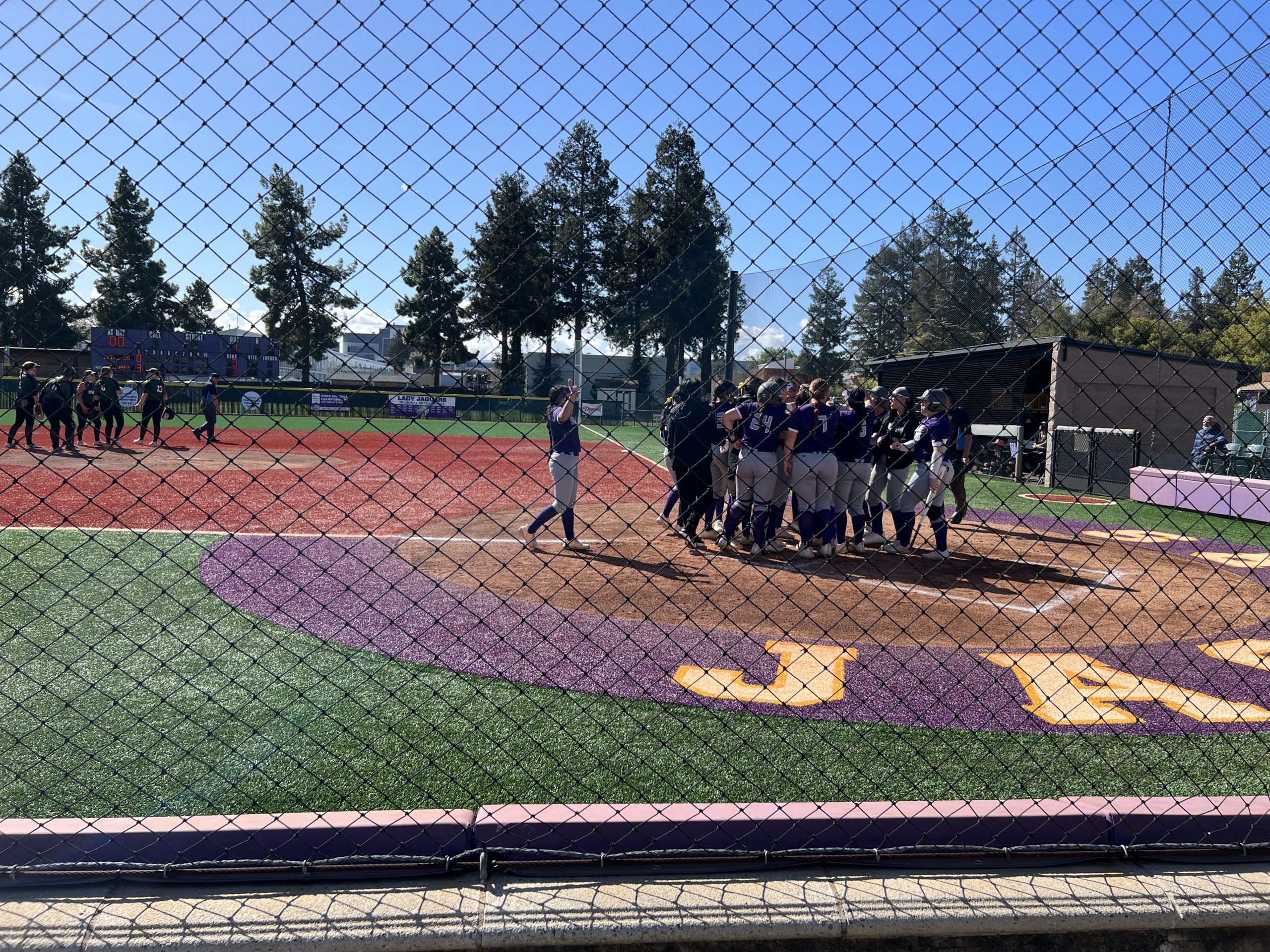 Lady Jaguars Celebrating No. 00 Haley Castros homerun.