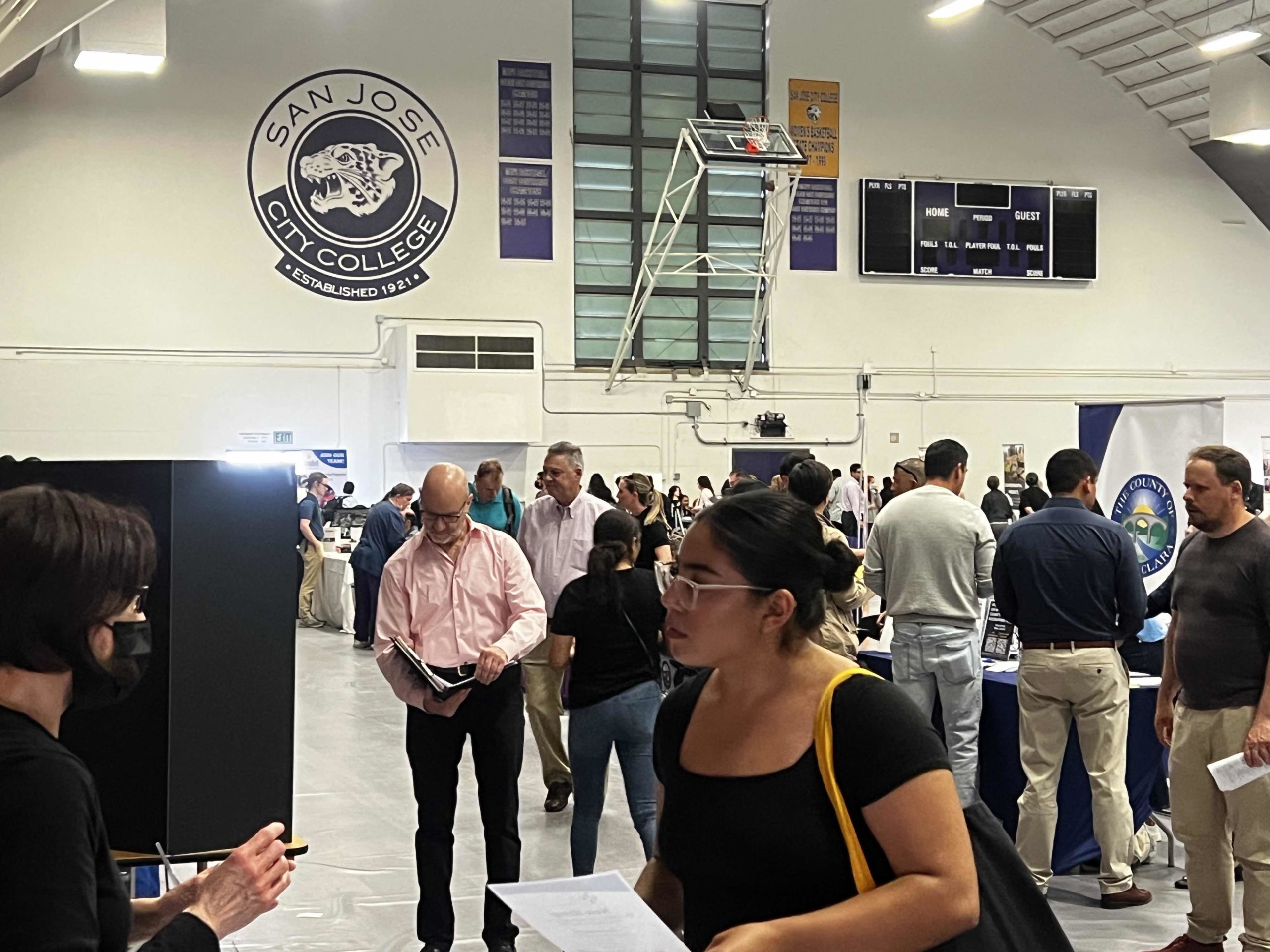 Attendees are actively networking with potential recruiters at the biannual spring career fair at San Jose City College, on April 25.