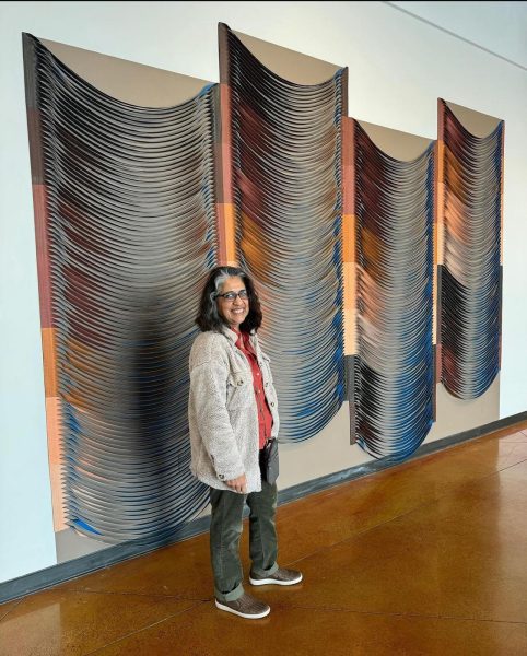 The Media artist Pilar Aguero in front of her wall mural: Lace Curve Relief,2022-2024 at Carmen Castellanos Gallery.

