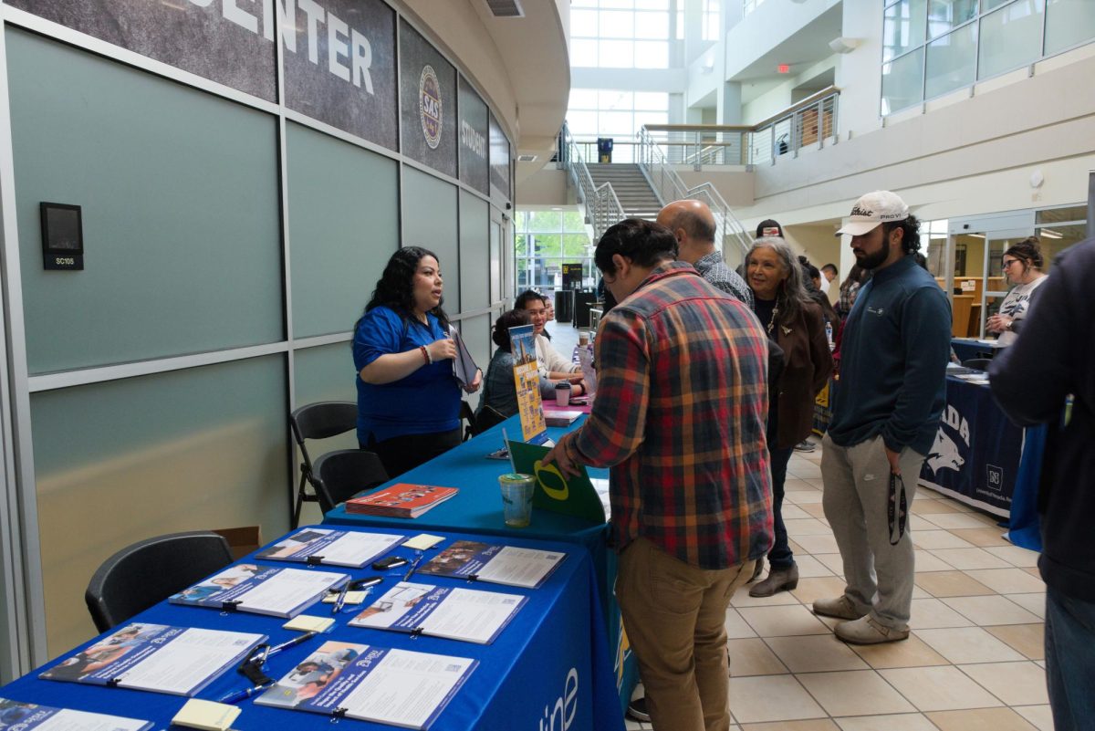 A San Jose State University representative converses with students.