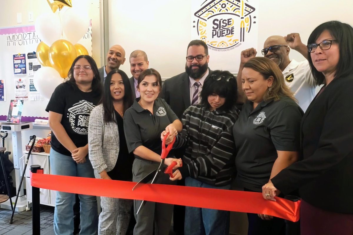 SJCC President Rowena Tomaneg, various staff members watch student Ixta Bautista cut the ribbon for Sí Se Puede's new center. // Virgil Aspen for the City College Times