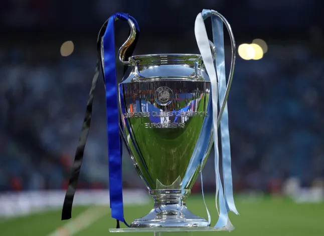 Champions league trophy being presented with dark blue and black ribbons for Chelsea and light blue for Manchester City ahead of their Champions league final match on May 29, 2021