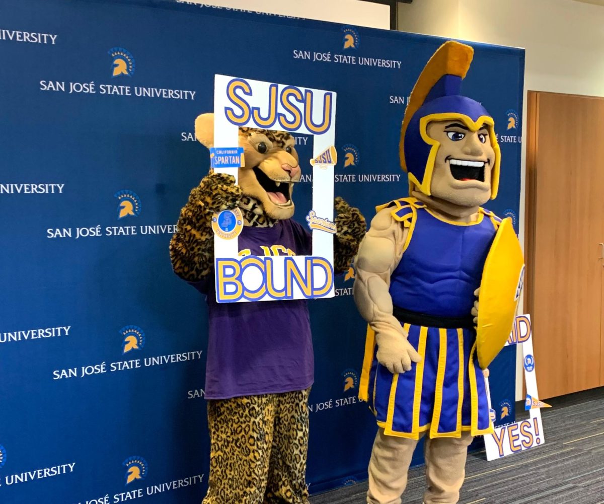 Jaggy the Jaguar and Sammy Spartan pose at the signing event.