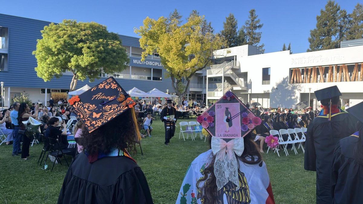 Latinx grads await their turn on stage at La Raza commencement. 